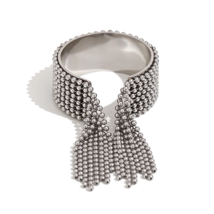Silver wide cuff bracelet with multiple layers of hanging bead tassels in minimalist style