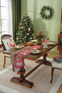 Detailed view of woven Christmas table runner with snowman patterns and red tassels