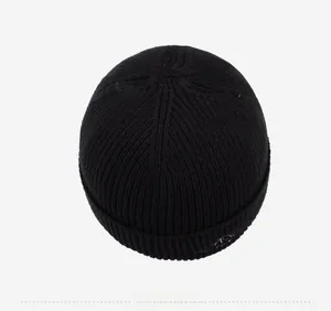 Top down detail of black ribbed knit beanie showing high-quality stitching and texture