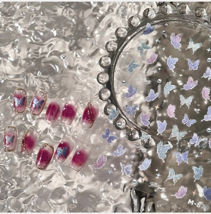 Macro detail of M-870 aurora butterfly nail stickers with holographic shimmer effects