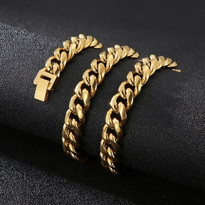 Détail macro d'une chaîne cubaine dorée de 10mm avec fermoir à boîte sur support texturé