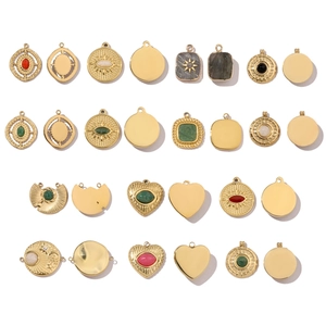 Macro view of polished gold geometric pendants with colorful natural stone inlays