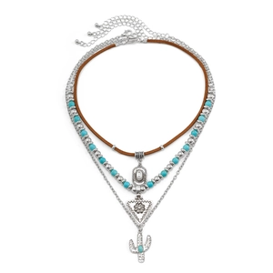Detailed close-up of bohemian layered necklace with turquoise beads and cactus pendant