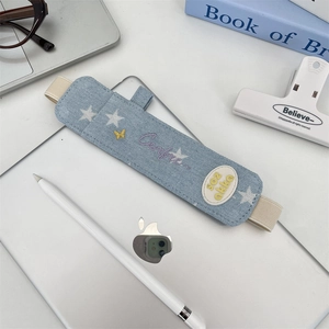 Detail of denim stylus holder with embroidery and elastic band on a tablet case