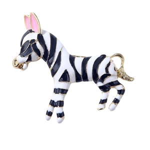 Vintage style zebra brooch with black and white enamel and golden trim on white background
