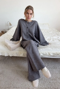 Close-up of dark grey knitted loungewear set featuring soft fabric and button details