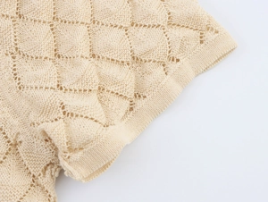 Detail of hollow diamond-pattern knit fabric on beige short-sleeve cardigan top