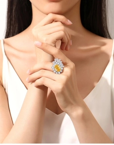 Macro detail of S925 silver ring featuring a large oval yellow diamond and marquise accents