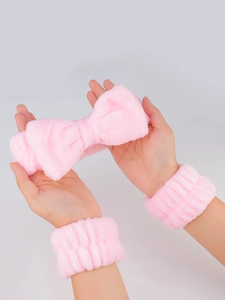 Close-up of pink microfiber bow headband and matching wristbands for face washing