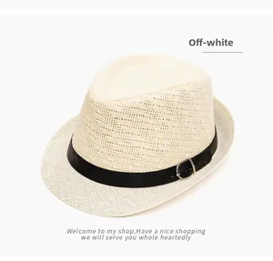 Detail of off-white straw fedora featuring a fine woven texture and black ribbon band