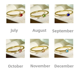 Macro display of 18K gold plated birthstone rings featuring colorful round cut crystals