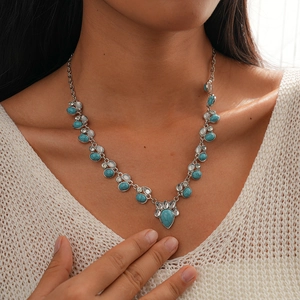 Detail of vintage bohemian necklace with blue turquoise stones and silver accents