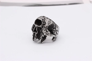 Detail of retro gothic skull ring featuring weathered texture and oxidized silver finish