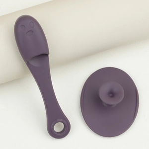 Close-up of purple silicone facial cleanser and nose brush tool for pore cleaning