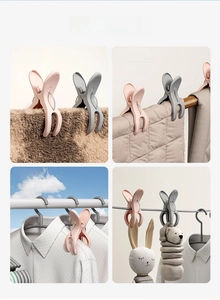 Close-up of windproof plastic clips holding heavy quilts and laundry on a balcony line