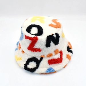 Detailed close-up of white plush bucket hat with colorful embroidered 3D letters