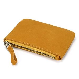 Close-up of yellow genuine leather coin purse showing suede texture and metal zipper