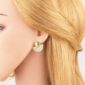Fashionable gold plated fan shaped stud earrings with sparkling cubic zirconia on model