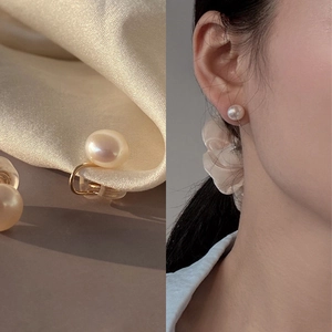 Detail of elegant freshwater pearl ear clip for non-pierced ears with gold metal finish