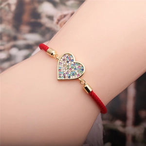 Adjustable red rope bracelet with gold heart pendant and colorful zircon crystals