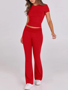 Detail of red two-piece set featuring short-sleeved crewneck top and high-waisted flared pants