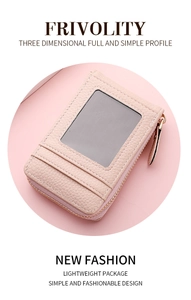 Macro shot of pink litchi leather card holder featuring a clear ID window and gold zipper