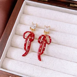 Vintage style red bow pendant earrings with zircon stones and gold floral patterns