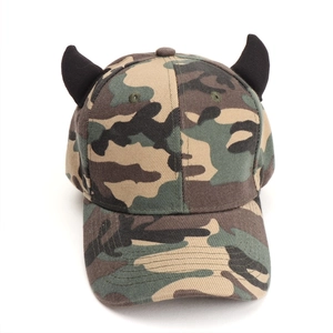 Detail of camouflage baseball cap featuring black 3D demon horn accents on the top