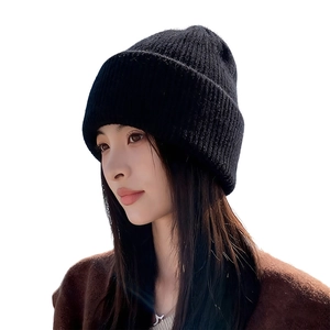 Women's thick black knit rabbit fur beanie with ear protection for winter warmth