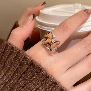 Macro shot of a wooden rocking horse ring with zircon inlay worn in a lifestyle setting