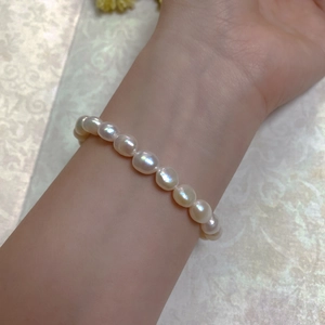 Close-up of a Baroque pearl bracelet with 14K gold-filled clasp on a woman's wrist