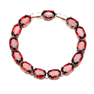 Elegant rose gold bracelet featuring oval-cut red garnet zirconia in a classic prong setting