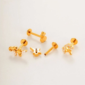 Titanium gold piercing set featuring zircon leaf crown and tree of life studs