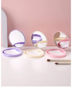 Close-up of portable round mirror and comb sets in purple, yellow and pink colors