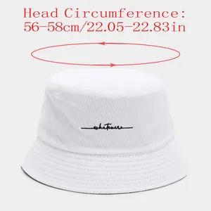 Detail view of a white corduroy bucket hat with head circumference measurement guide