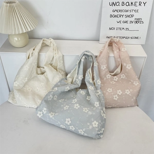 Detailed embroidery view of hollow floral lace tote bags in beige, pink, and blue colors
