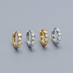 Macro shot of 925 silver hoop earrings featuring square and round clear cubic zirconia