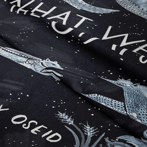 Macro detail of high-density flannel fabric featuring mystical wolf and star print