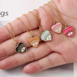 Colorful enamel heart eye necklaces set in gold stainless steel finish displayed on hand