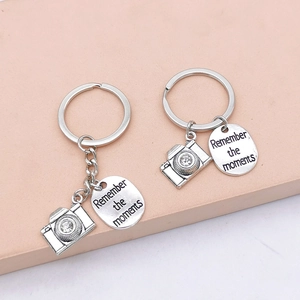 Silver camera keychain set with crystal accents and Remember the moments engraved tag