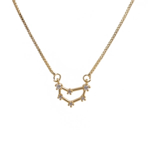 Close-up of golden zodiac pendant necklace with sparkling cubic zirconia on box chain
