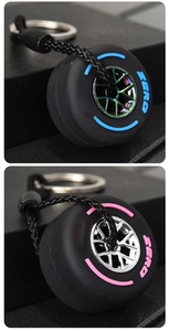 Macro detail of zero tire keychain with electroplated rims and woven lanyard strap