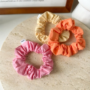 Three-piece set of macaron-colored cotton hair scrunchies in pink orange and yellow
