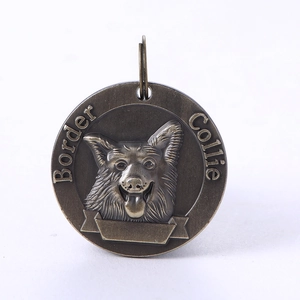 Detailed relief of a Border Collie on a vintage bronze pet ID tag with engravable area