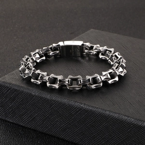 Macro shot of 316L stainless steel bracelet links on black textured packaging box