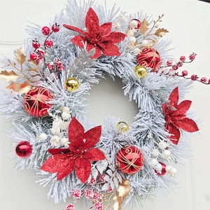 Christmas wreath with red poinsettia and flocked needles for door hanging decoration