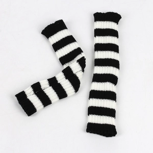 Macro detail of elastic knitted arm warmers with classic black and white striped pattern