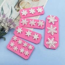 Pink silicone mold detail showing various snowflake sizes for fondant and cake decoration