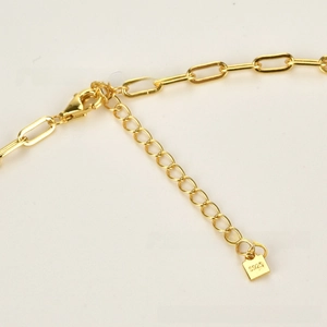 Macro shot of 18K gold plated S925 sterling silver chain with lobster clasp and hallmark tag