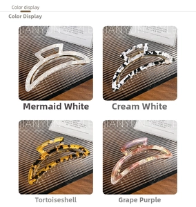Detail view of four acetate hair claws in mermaid white and tortoiseshell patterns